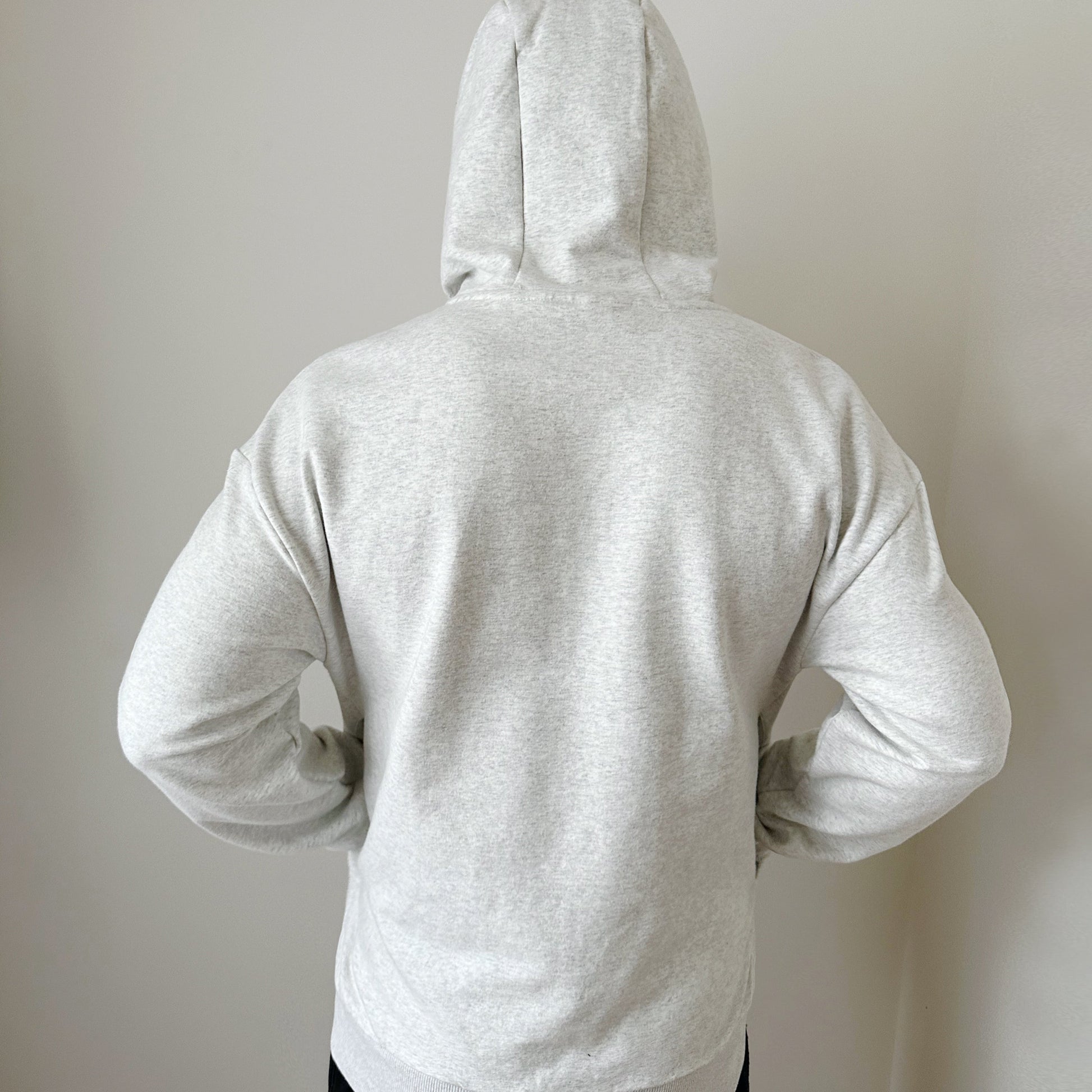 model wearing heather grey hoodie from back side